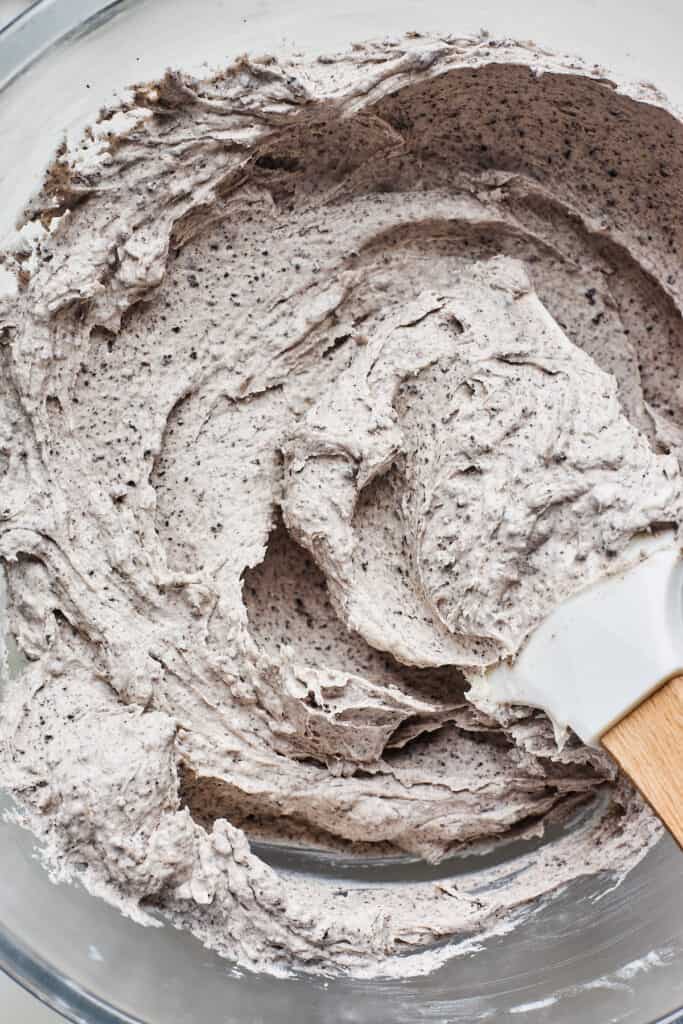 Oreo buttercream close up in a bowl with a spatula on the top