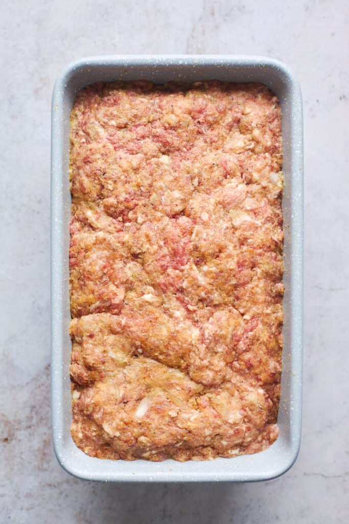 Mixed meat put into a loaf pan before baking