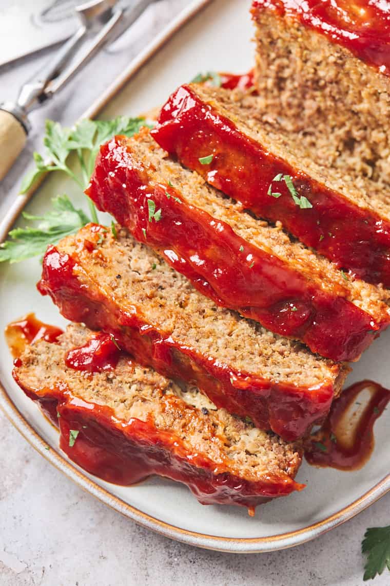 A close up of the most perfect meatloaf ever with slices ready to serve
