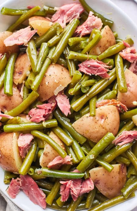 A close up of southern green beans with potatoes with ham hock