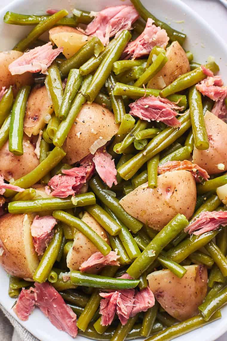 A close up of southern green beans with potatoes with ham hock