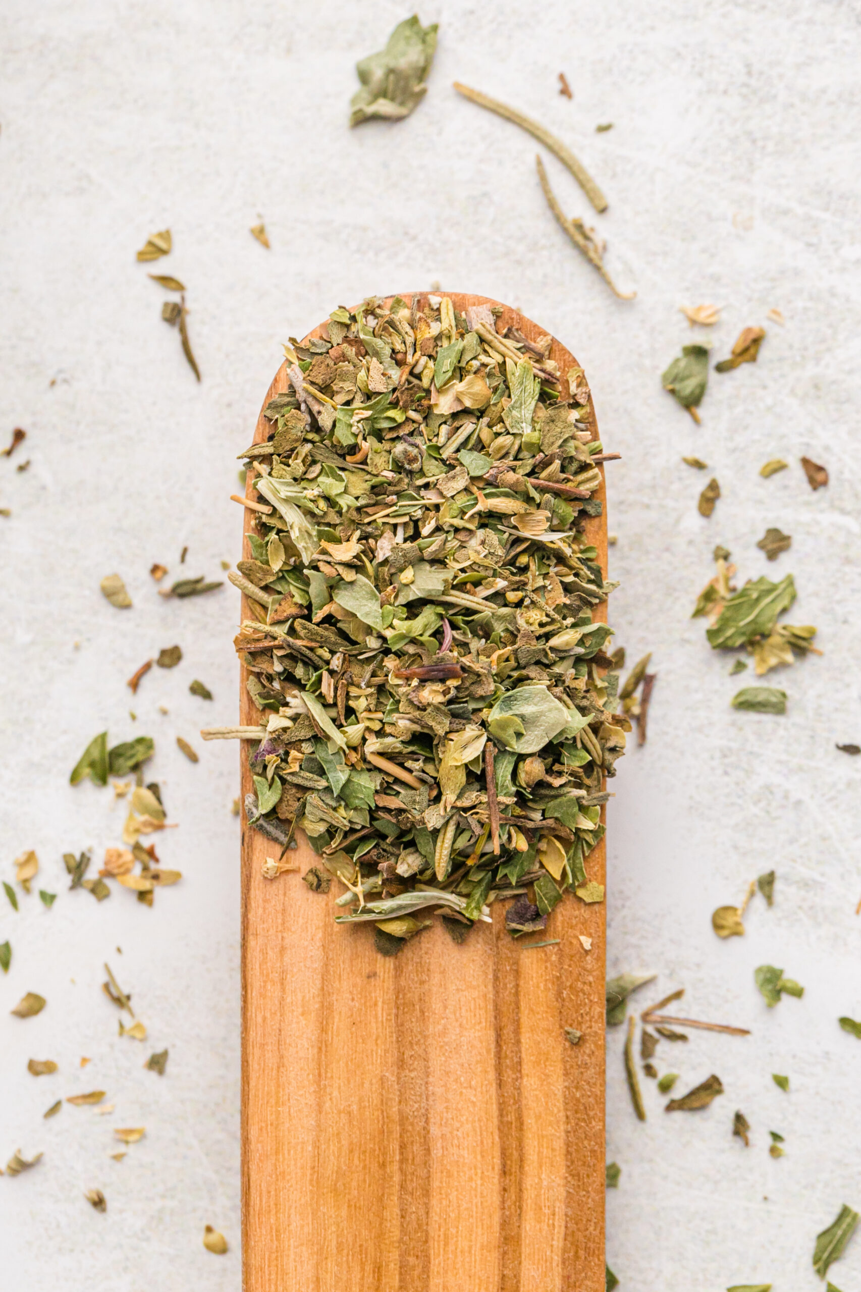 A wooden spoon filled with a homemade spice blend