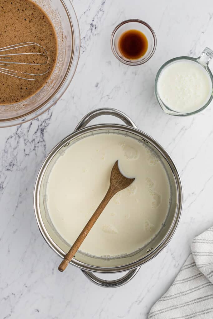 An ice cream custard being stirred with a wooden spoon