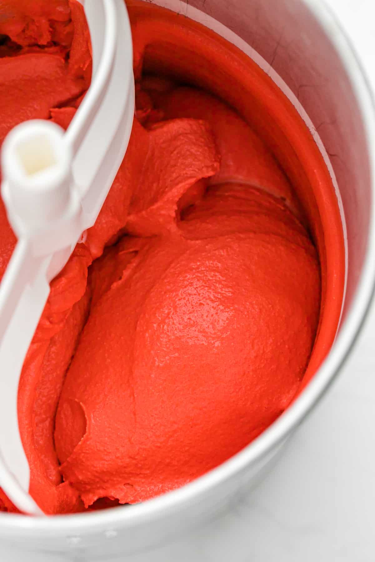 Red velvet ice cream being churned in an ice cream maker