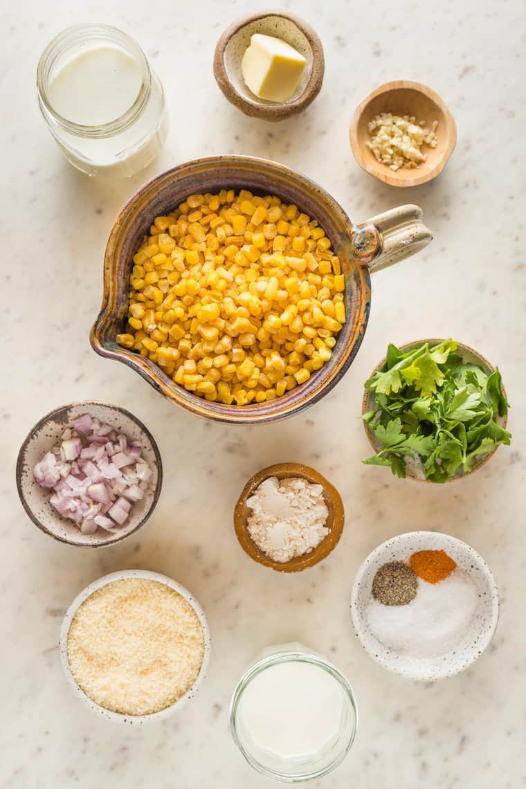Fresh corn, onions, parsley, cheese and spices to make a cream corn dish