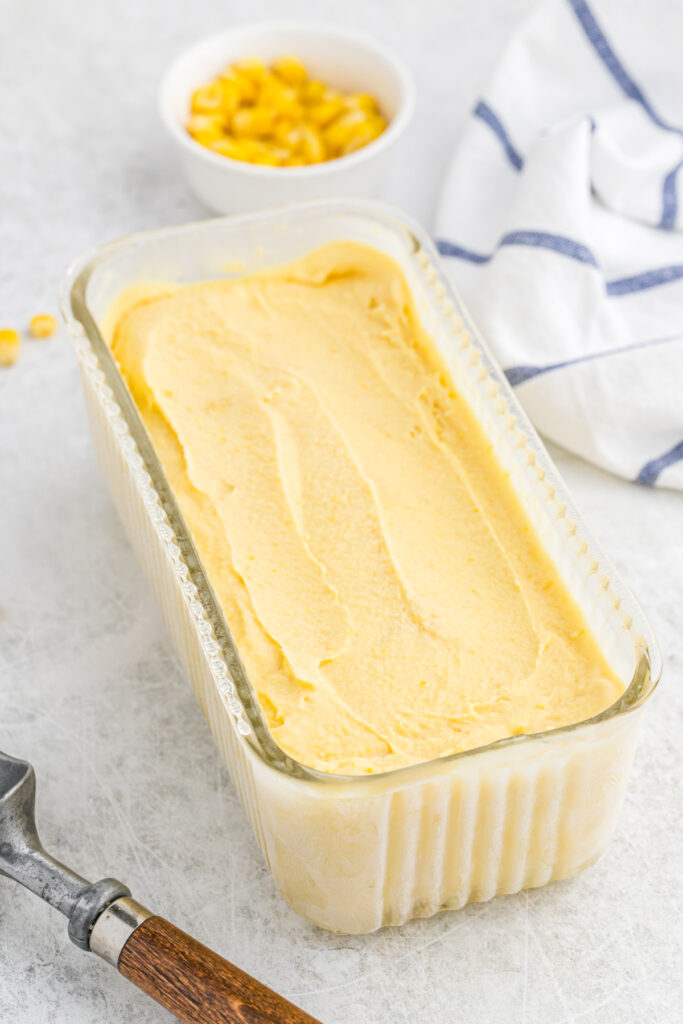 A delicious corn ice cream in a clear frozen canister after chilling