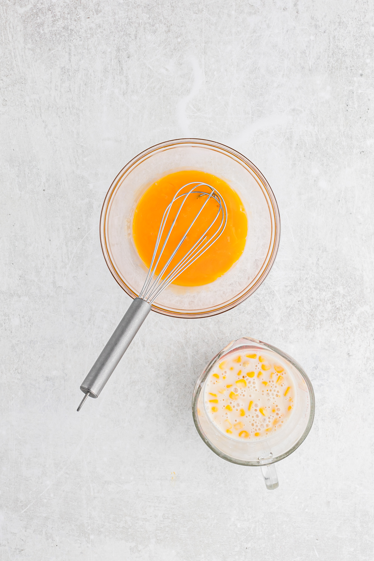 Egg yolks whisked together in a clear bowl