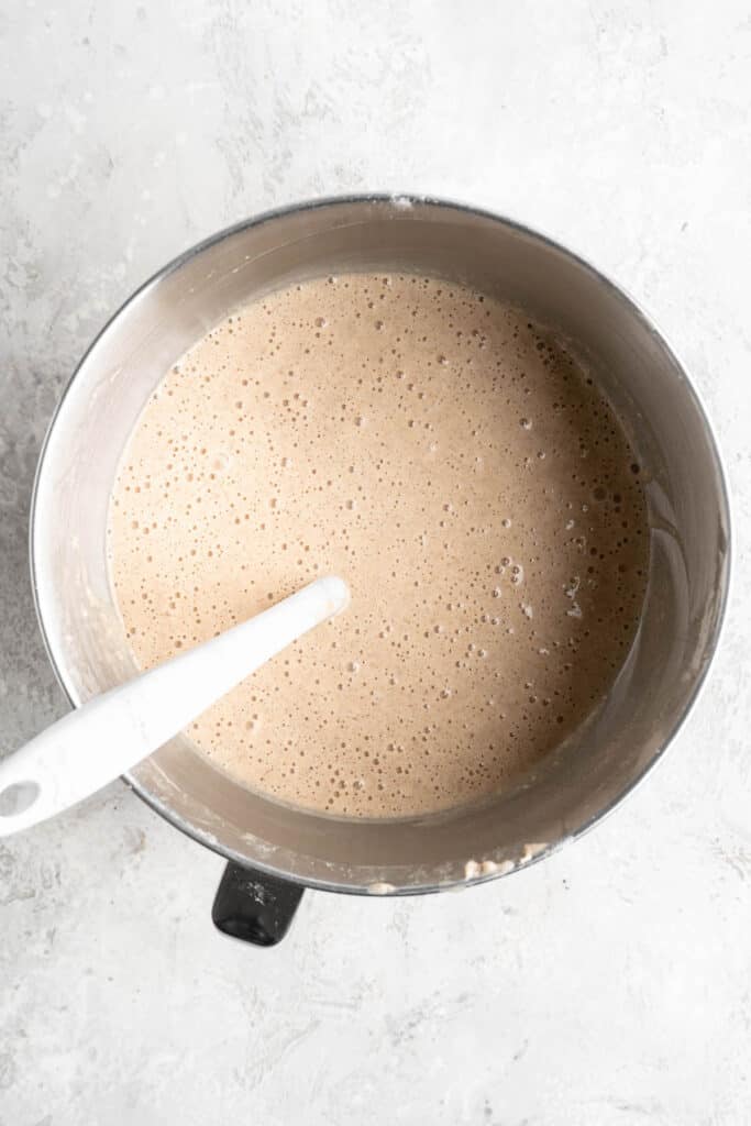 Cake batter in a mixing bowl after being mixed together on a white countertop
