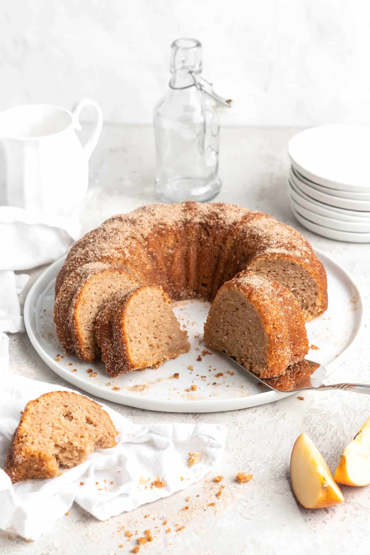 Slices of an apple cider donut cake against a white background