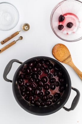 A large pot of cherries being thickened