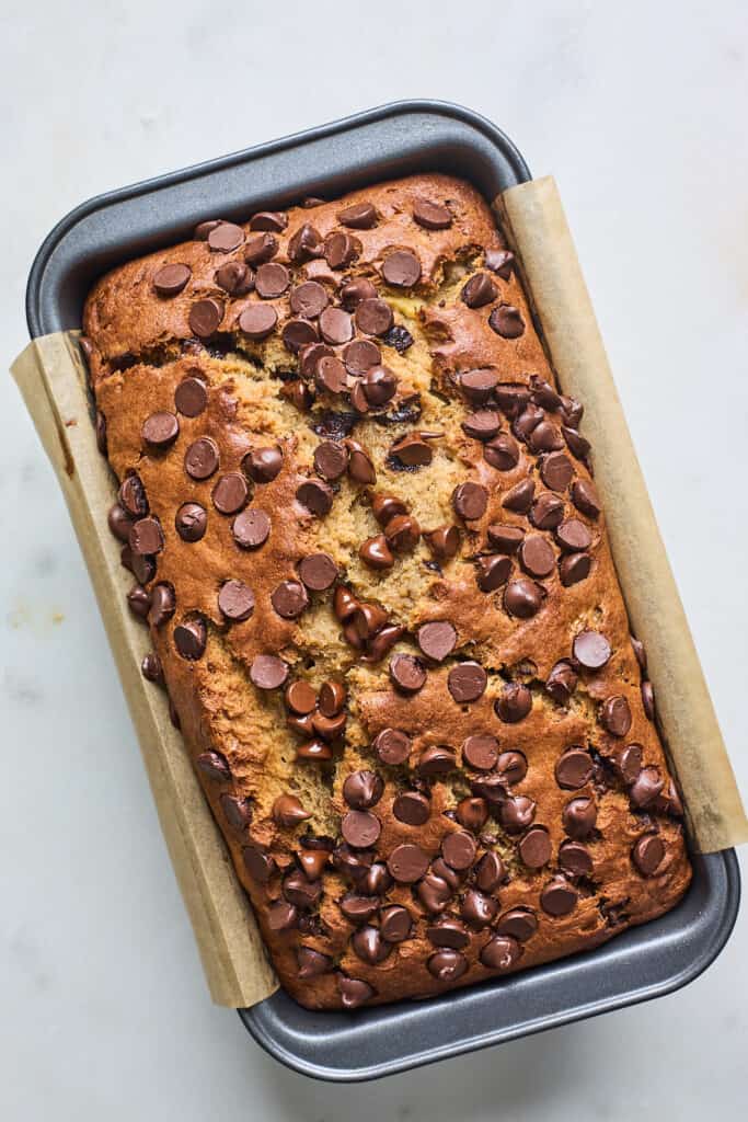 A delicious chocolate banana bread loaf baked inside a loaf pan cooling