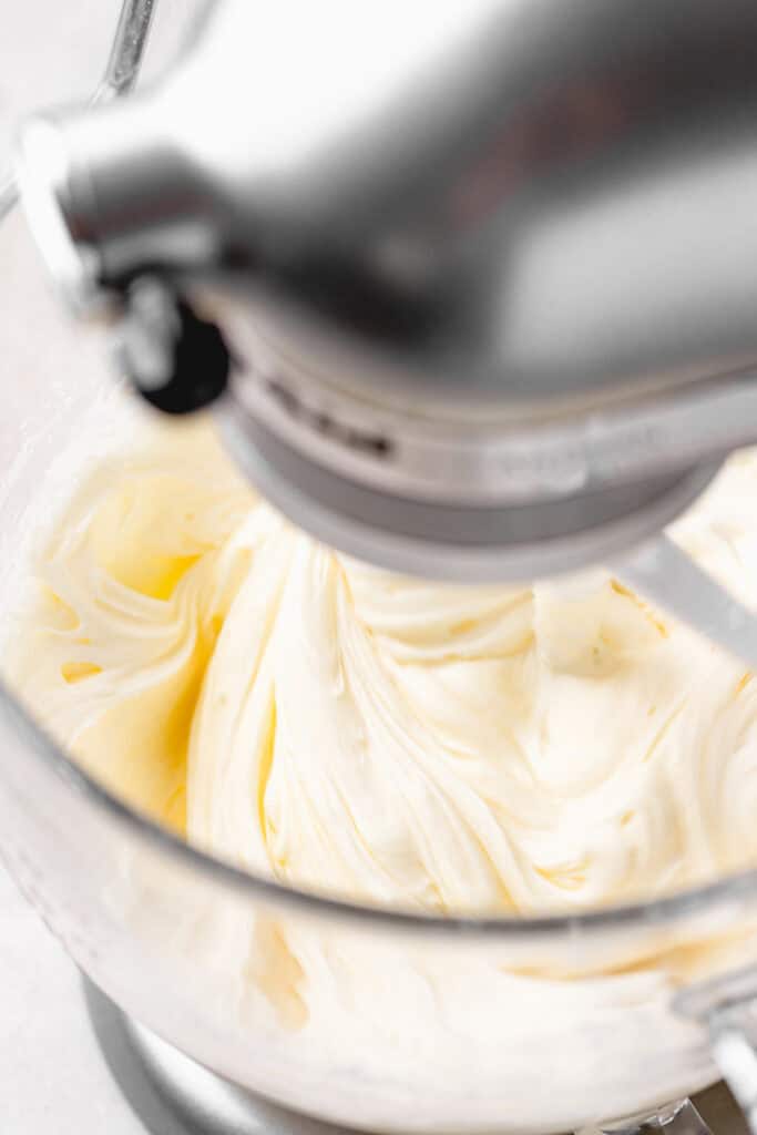 Cream cheese frosting being mixed in a stand mixer