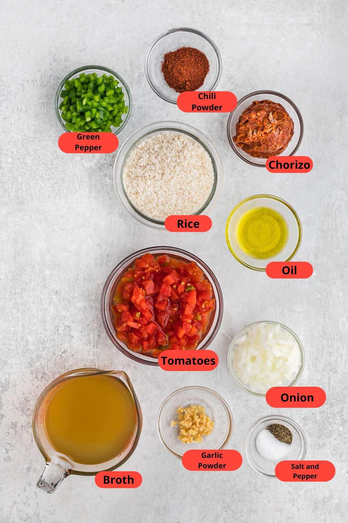 Ingredients to make a rice recipe including tomatoes, rice, broth, green pepper, onion