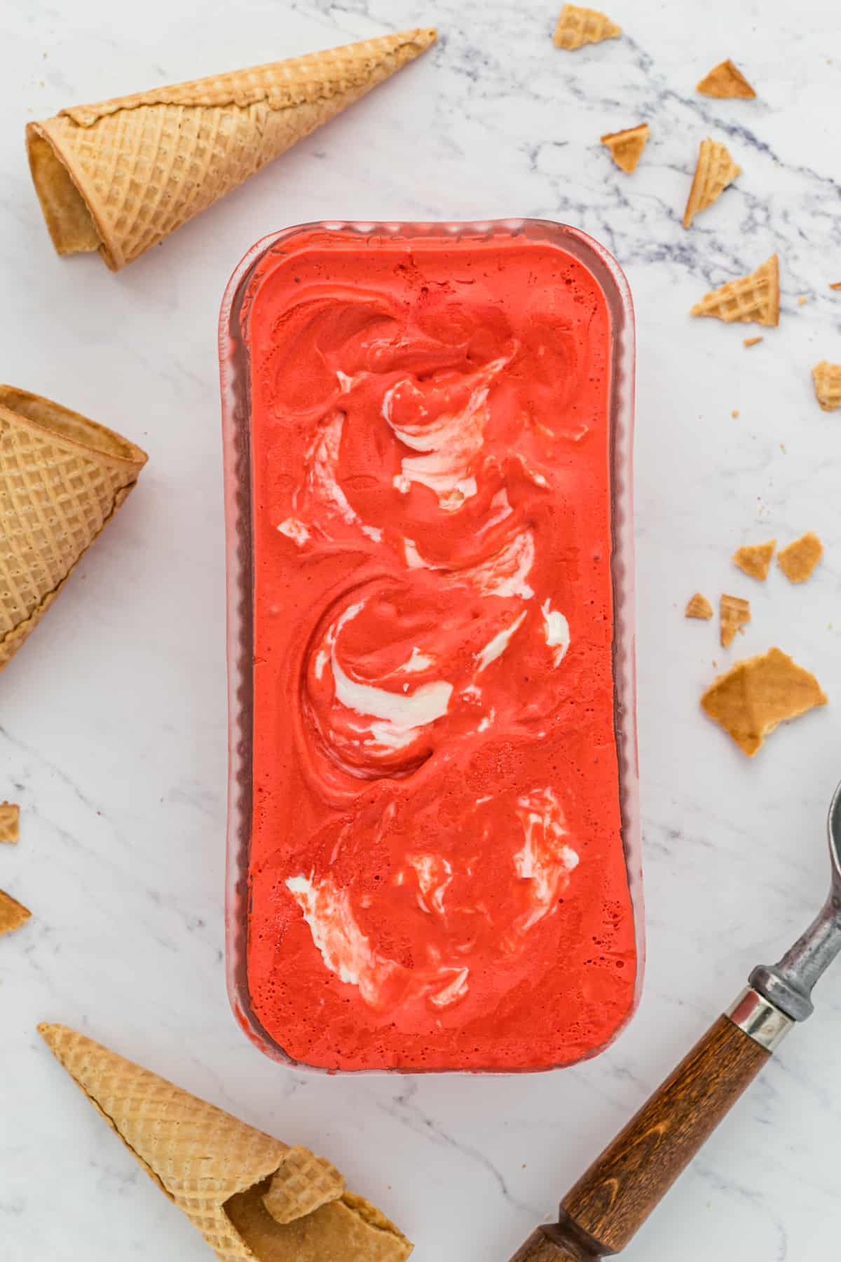 Red colored ice cream in a container after freezing