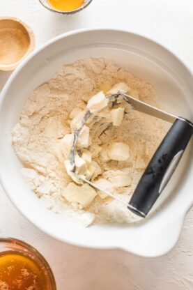 Butter being cut into dry flour mixture