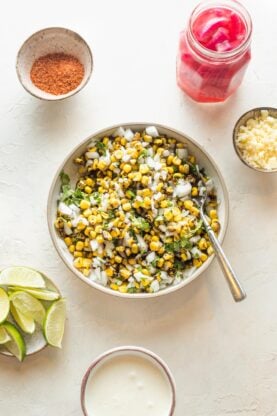 Grilled corn, onion and cilantro in a white bowl