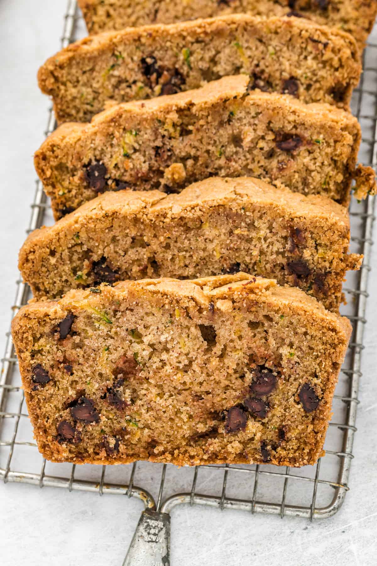 Chocolate Chip Zucchini Bread slices on a wire rack.