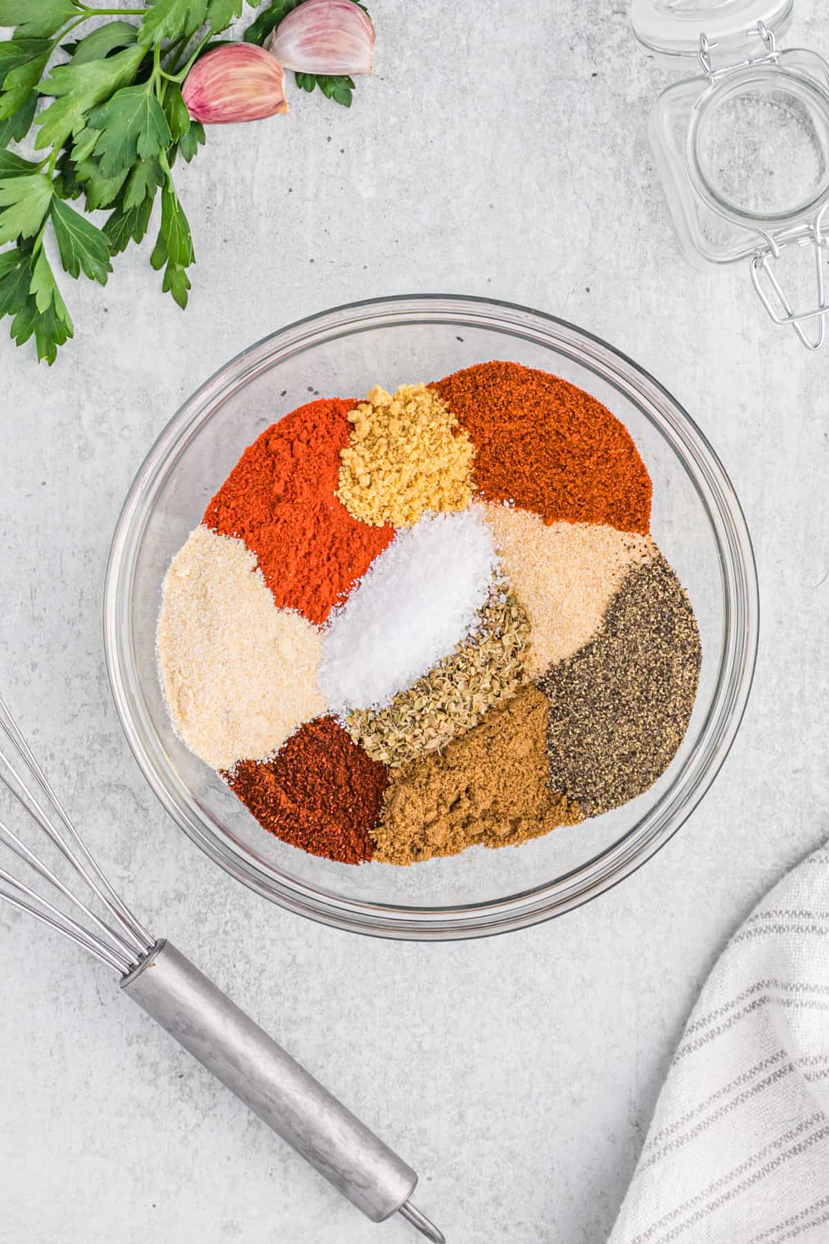 Colorful spices in a large mixing bowl ready to mix into dry turkey rub.