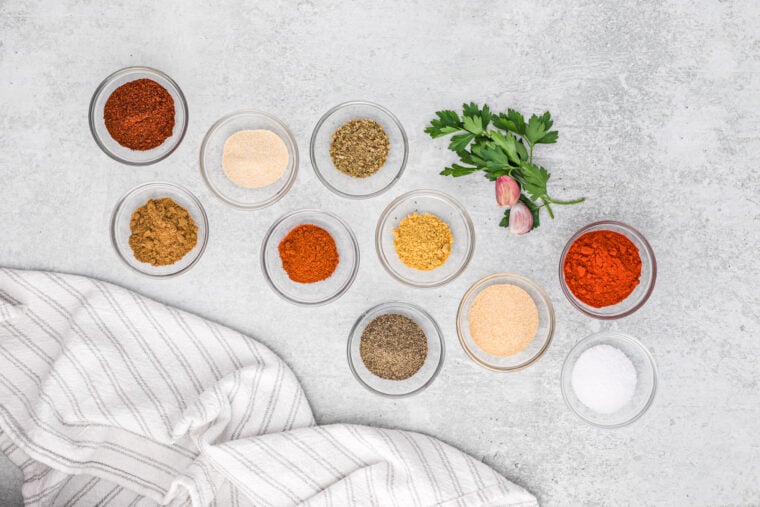 Small bowls filled with individual spices to make turkey seasoning rub