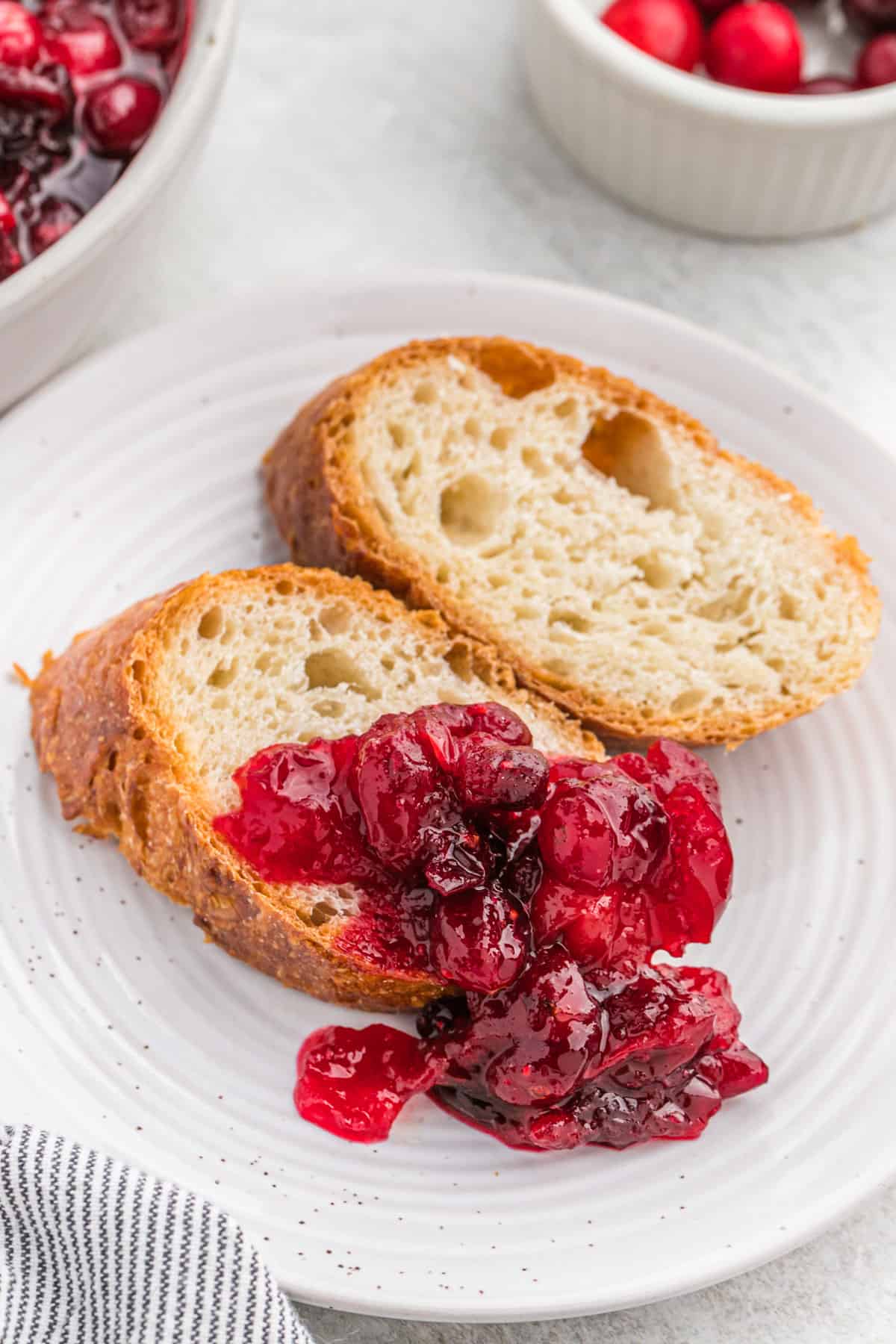 Whole berry cranberry sauce on baguette slices.