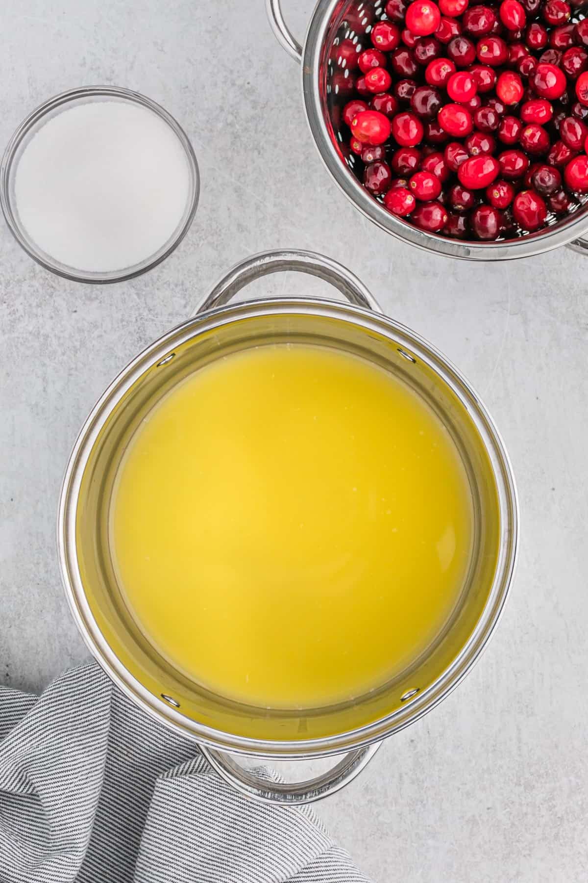 Orange juice in a saucepan ready to make cranberry sauce recipe.