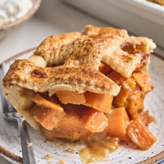 A slice of sweet potato cobbler on a small stoneware plate.