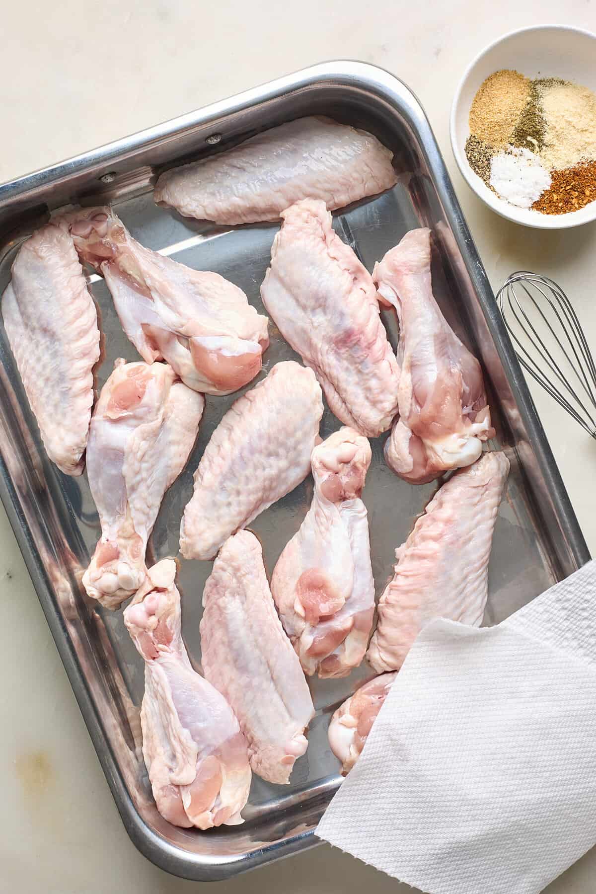raw turkey wings on a baking sheet