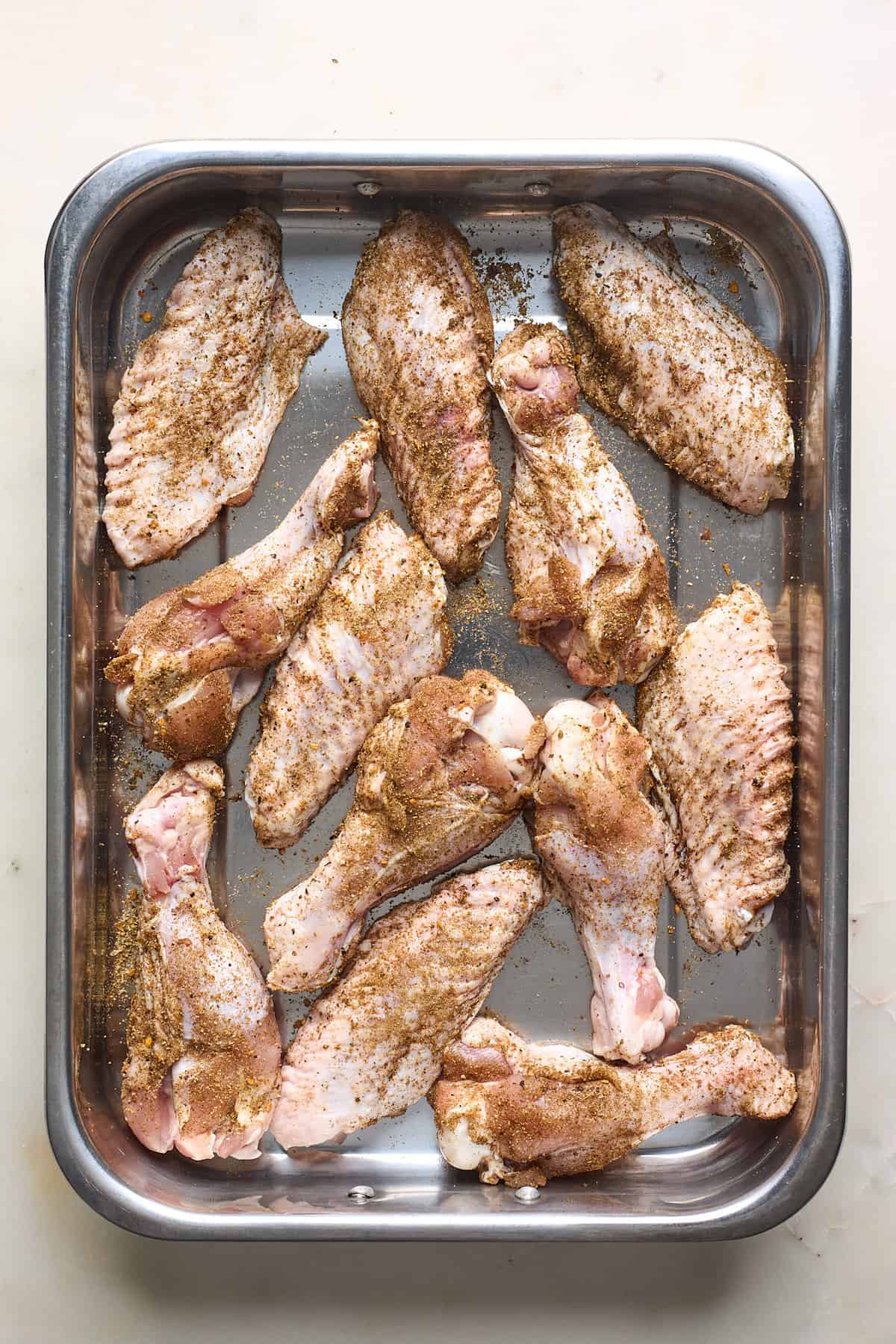 seasoned turkey wings on a baking sheet