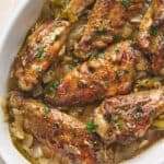 Overhead shot of baked turkey wings in a white dish