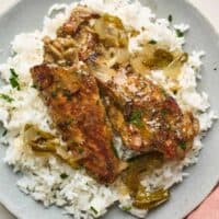 Turkey wings served on a plate over rice