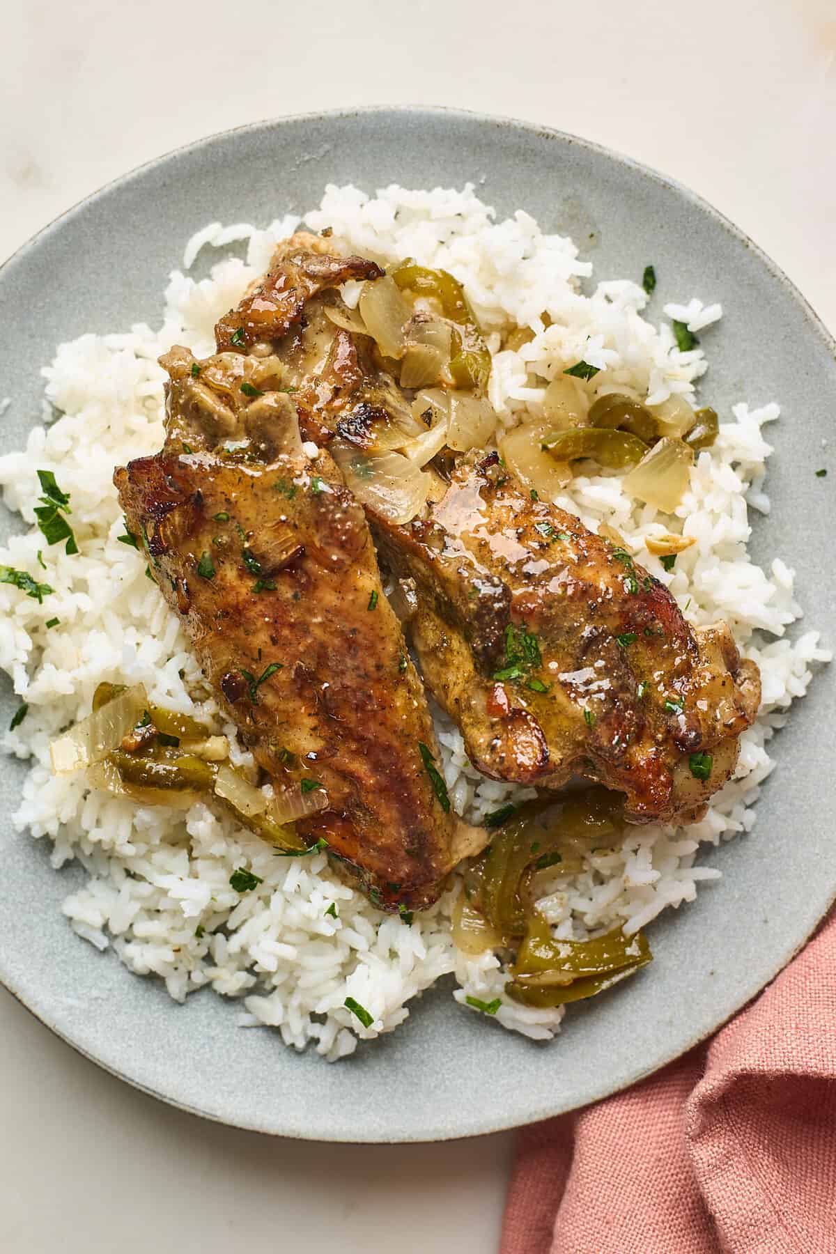 Turkey wings served on a plate over rice