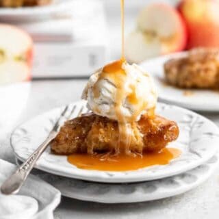 apple dumpling on a plate with caramel dizzle