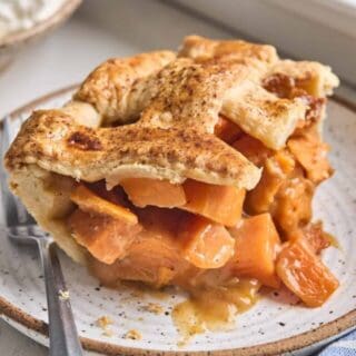 A slice of sweet potato cobbler on a small stoneware plate.