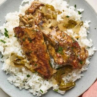 Turkey wings served on a plate over rice