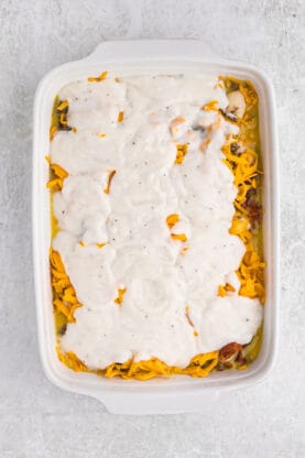 Gravy spread over cheese in a breakfast casserole before baking