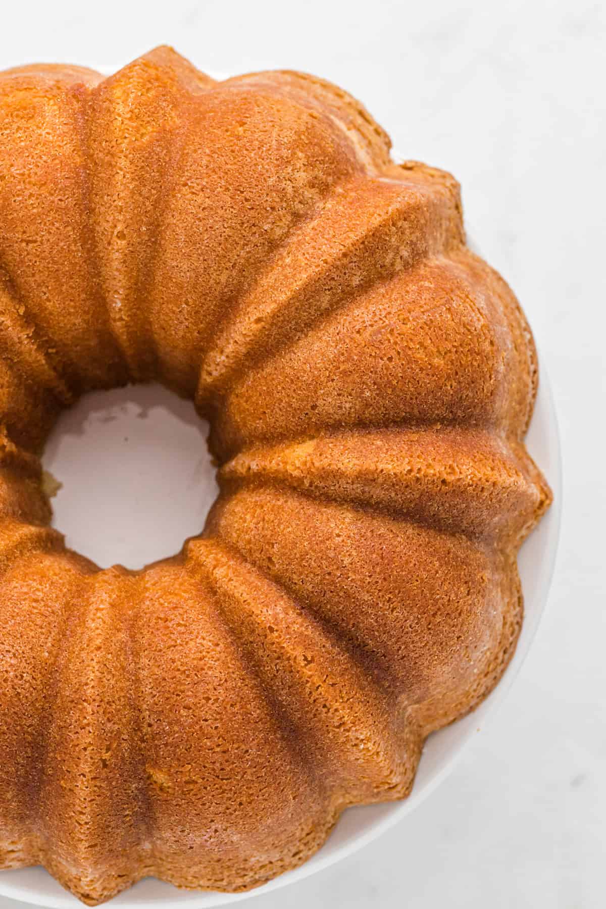 A perfect sour cream pound cake recipe plain on a white countertop