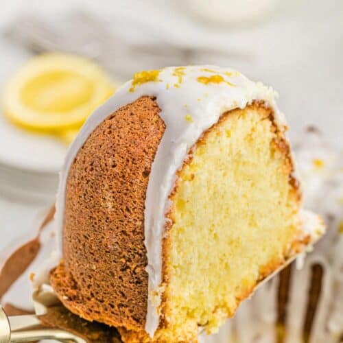 Slice of lemon pound cake on a cake spatula, showing a moist, tender crumb with lemon glaze