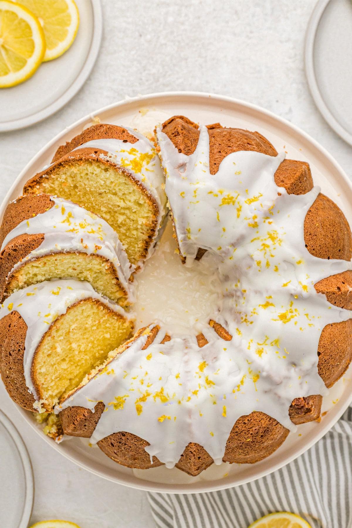 Overhead shot of glazed lemon pound cake, sliced and arranged on a serving plate
