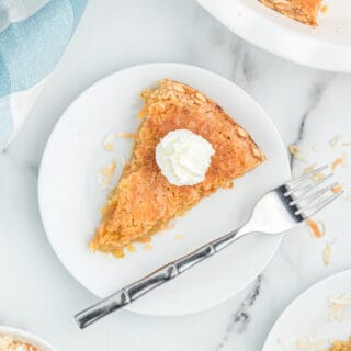 A slice of toasted coconut pie on a dessert plate.