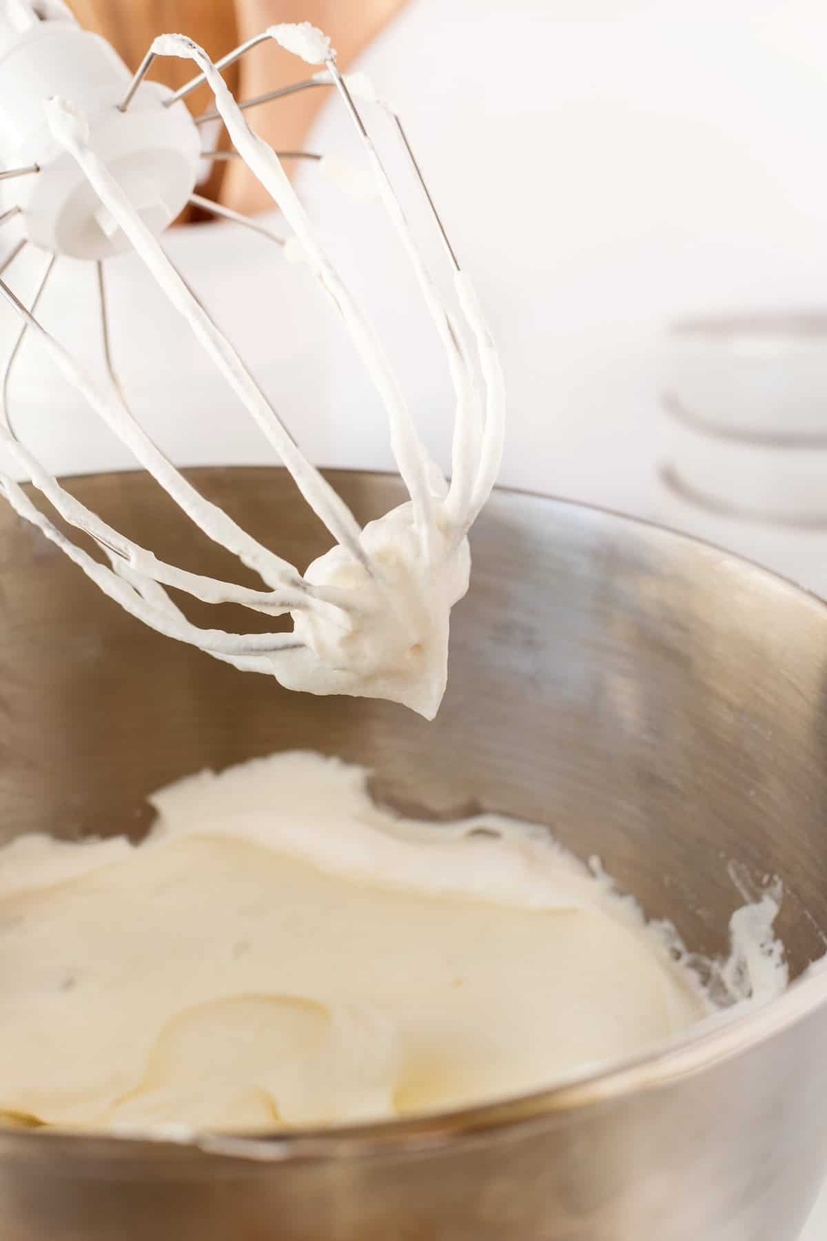 Whipped cream on whisk beaters after mixing up.