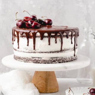 A black forest cake assembled on a cake stand.