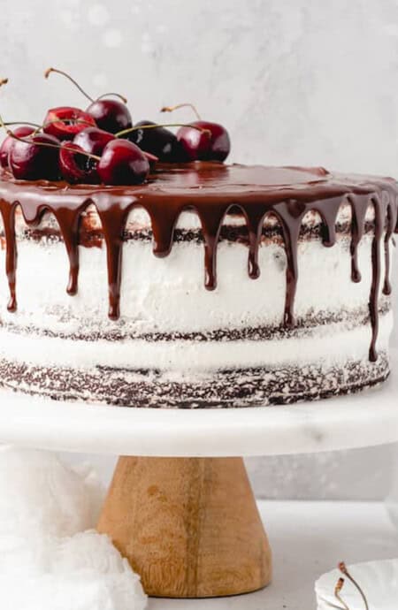 A black forest cake assembled on a cake stand.