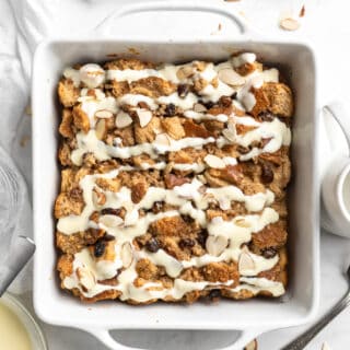 Bread pudding baked in a white square dish.
