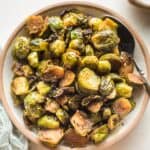 overhead of a bowl full of roasted brussels sprouts and a spoon