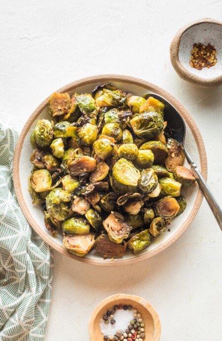 overhead of a bowl full of roasted brussels sprouts and a spoon