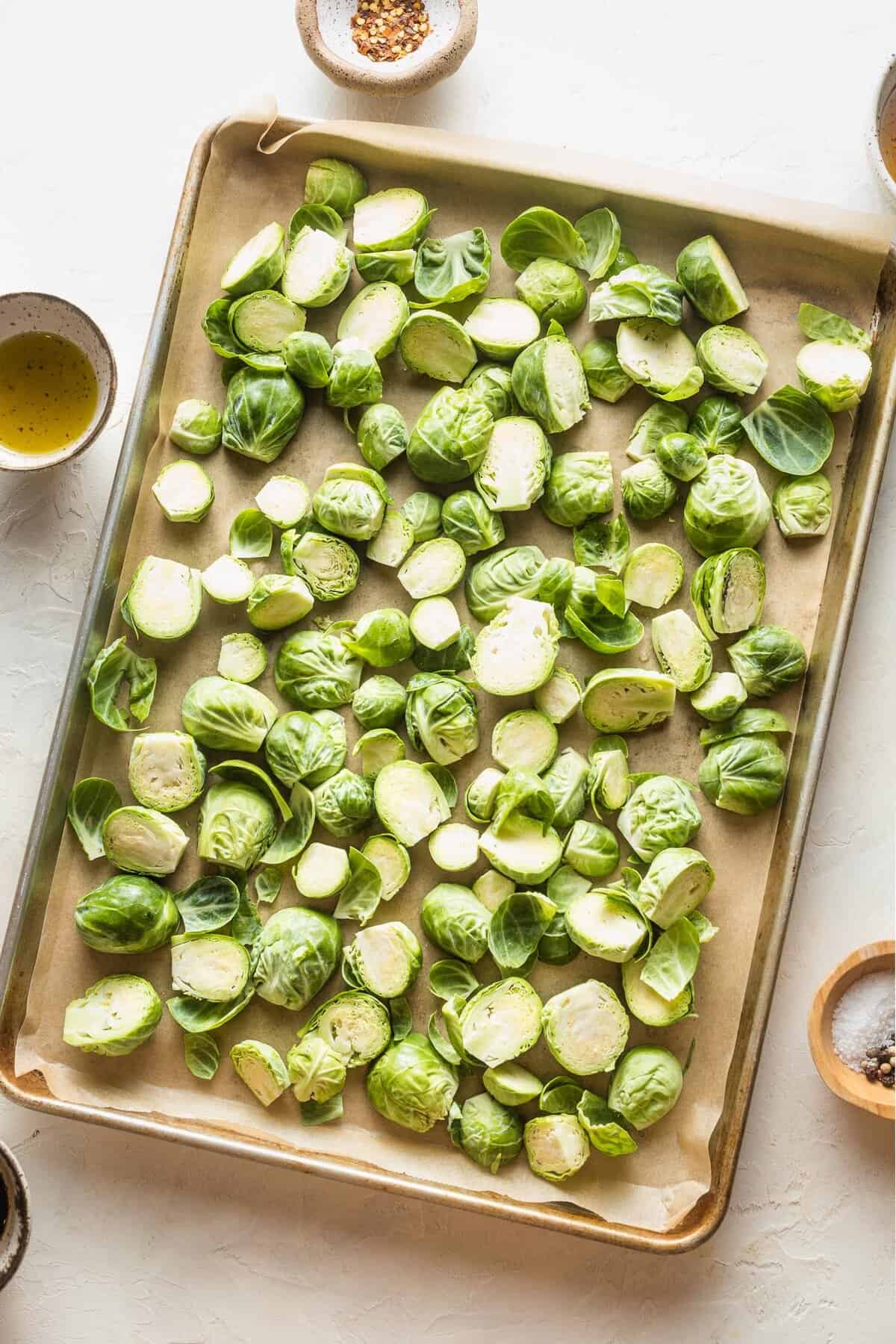 brussels sprouts lining a baking sheet