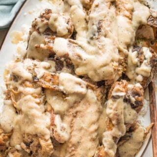 a platter full of smothered turkey wings ready to serve