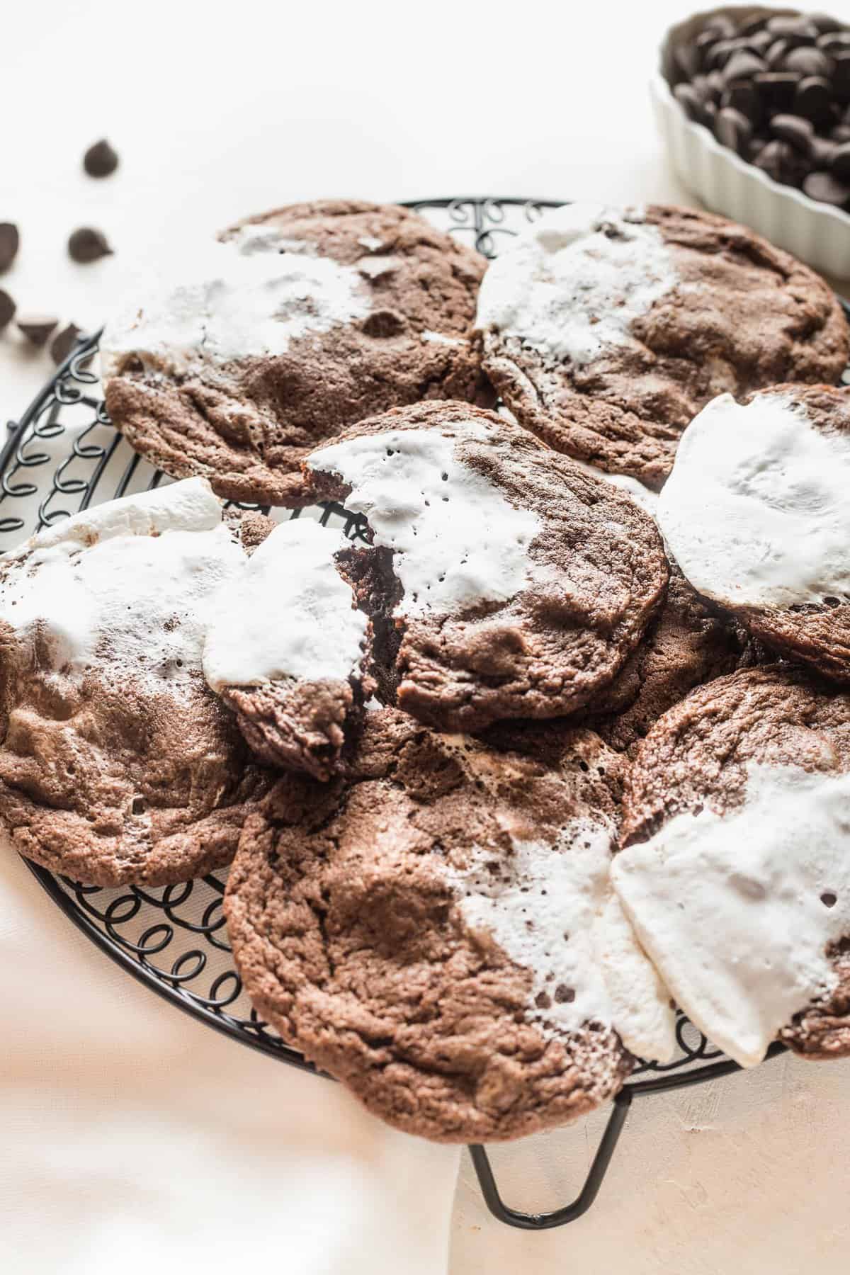 Hot chocolate cookies with marshmallow cooling on a wire rack.