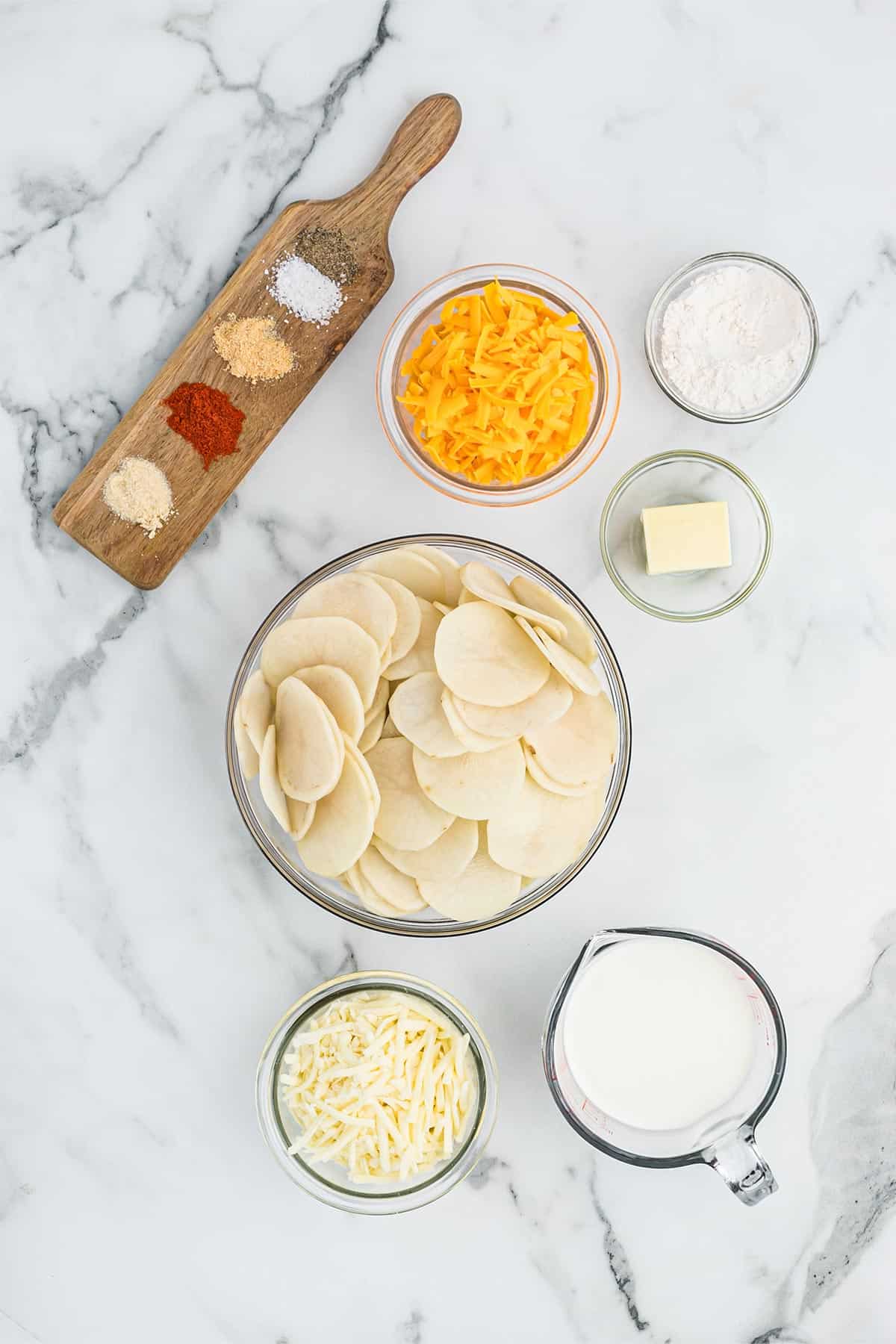Ingredients to make cheesy scalloped potatoes on the table.