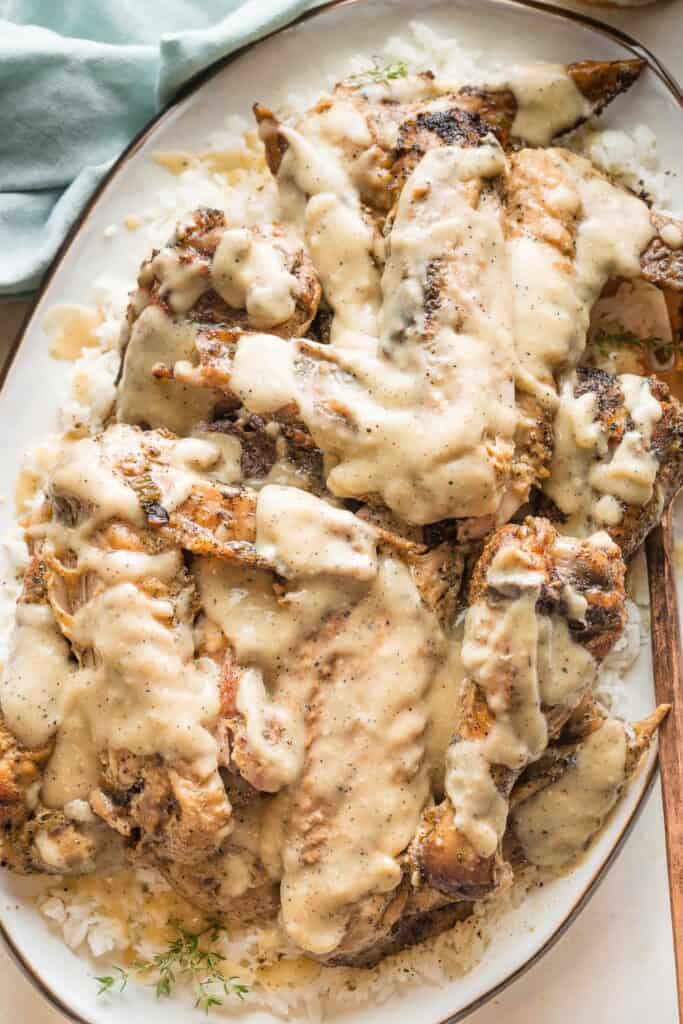 a platter full of smothered turkey wings ready to serve